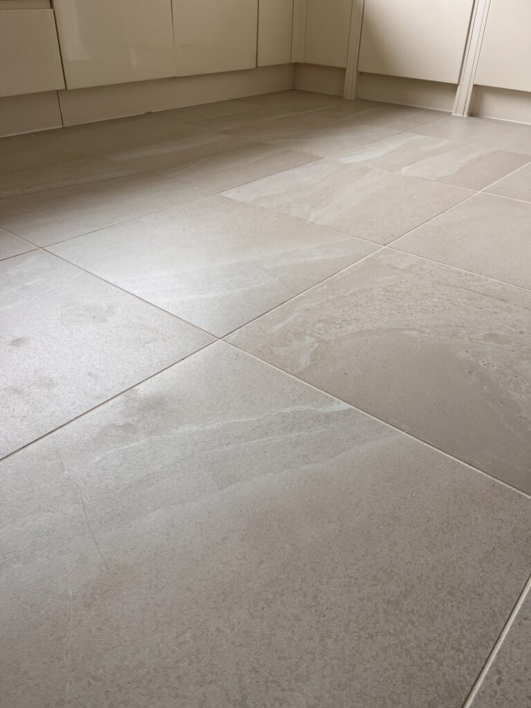 Light-coloured tiled kitchen floor.