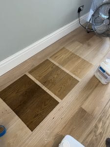 Oak floor stain test patches in three shades during engineered oak floor restoration, Norden, Rochdale