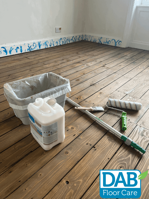 Floor care tools and materials arranged.