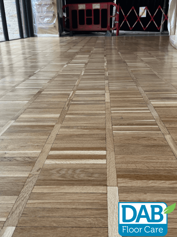 Polished wooden floor with intricate patterns.