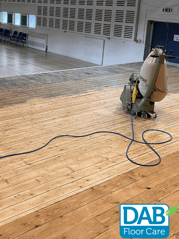 Sanded wooden floor with machine equipment.