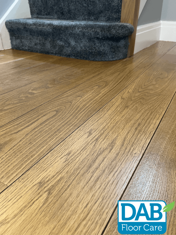 Polished oak floor near staircase.