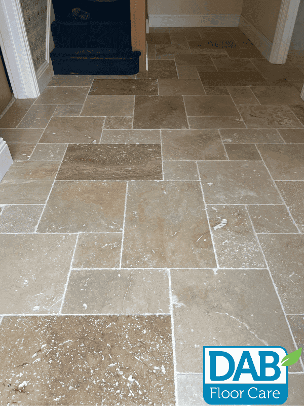 Cleaned natural stone floor with restored colour and grout